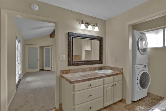 a bathroom with a granite countertop sink and a mirror