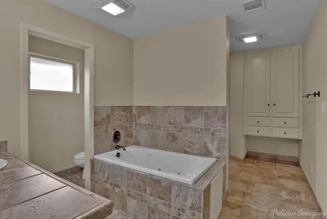 a bathroom with a tub and sink