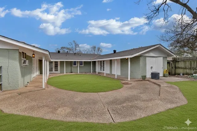 a front view of a house with a garden and plants