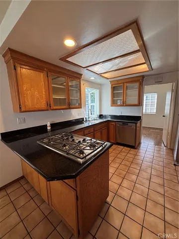 a kitchen with a stove a sink and a microwave