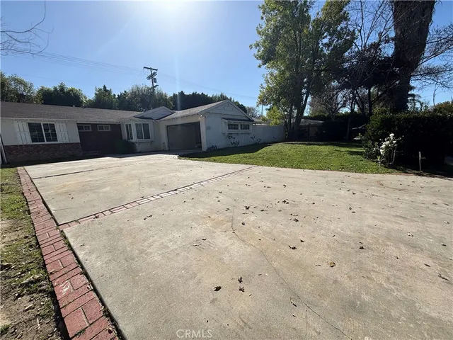 a pathway of a house with a yard