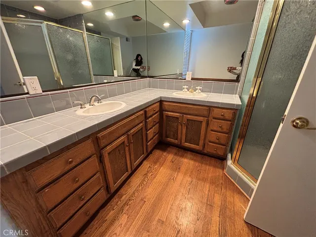 a bathroom with a sink double vanity granite and a mirror