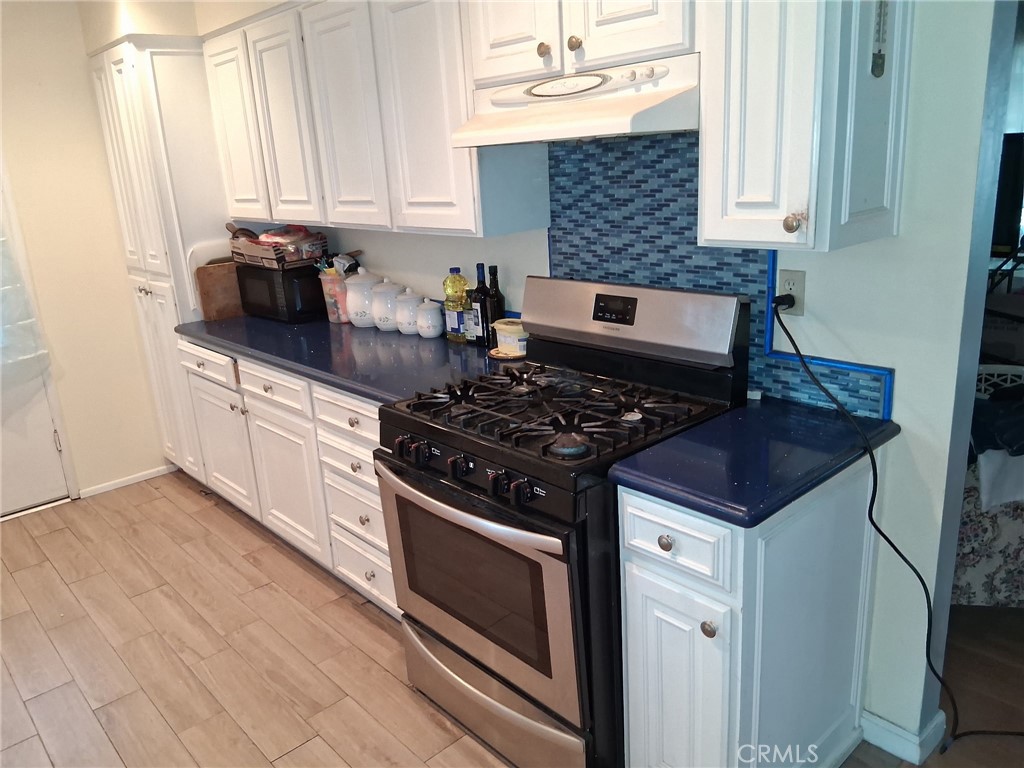 3631 La Costa Place Oxnard, CA 93033 - Photo 11 of 11 a kitchen with granite countertop a stove and a sink