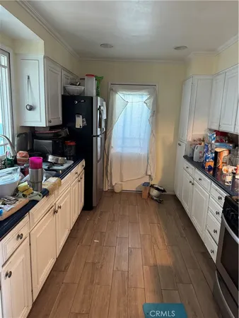 a kitchen with sink a refrigerator and cabinets