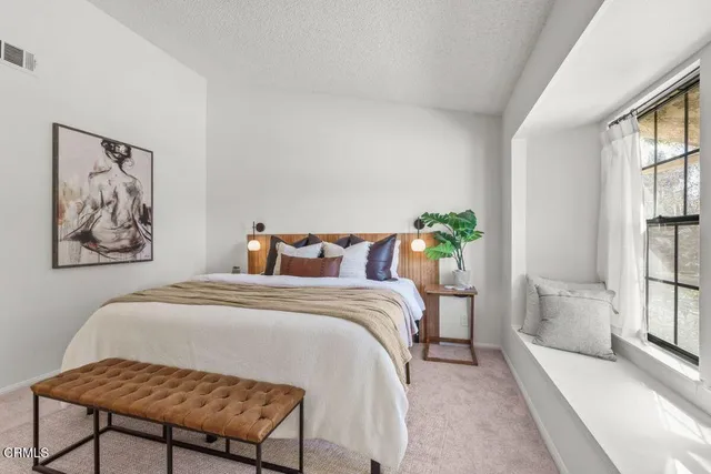 an aerial view of a house with a yard and sitting area