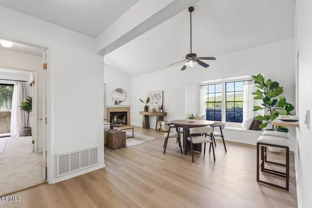 a view of a dining room with furniture window and wooden floor