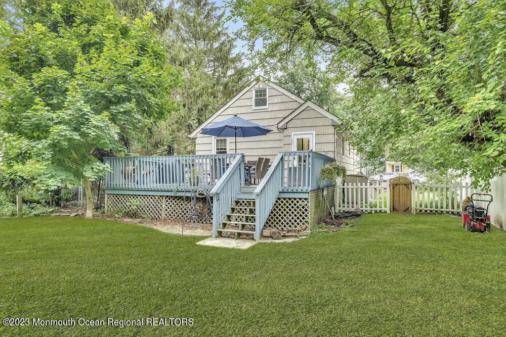 84 Ravine Drive Matawan, NJ 07747 - Photo 24 of 27 a front view of a house with garden and deck