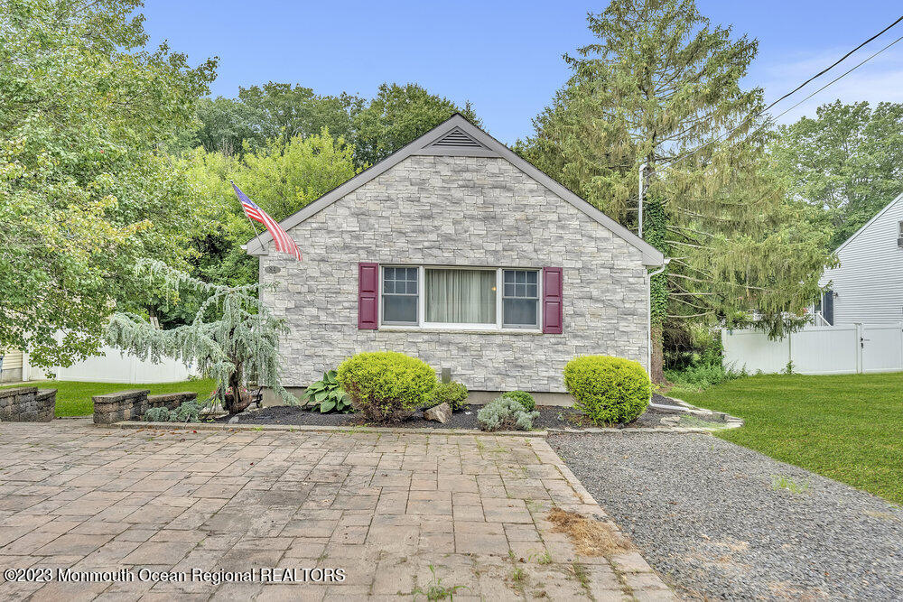 84 Ravine Drive Matawan, NJ 07747 - Photo 3 of 27 a front view of a house with a garden