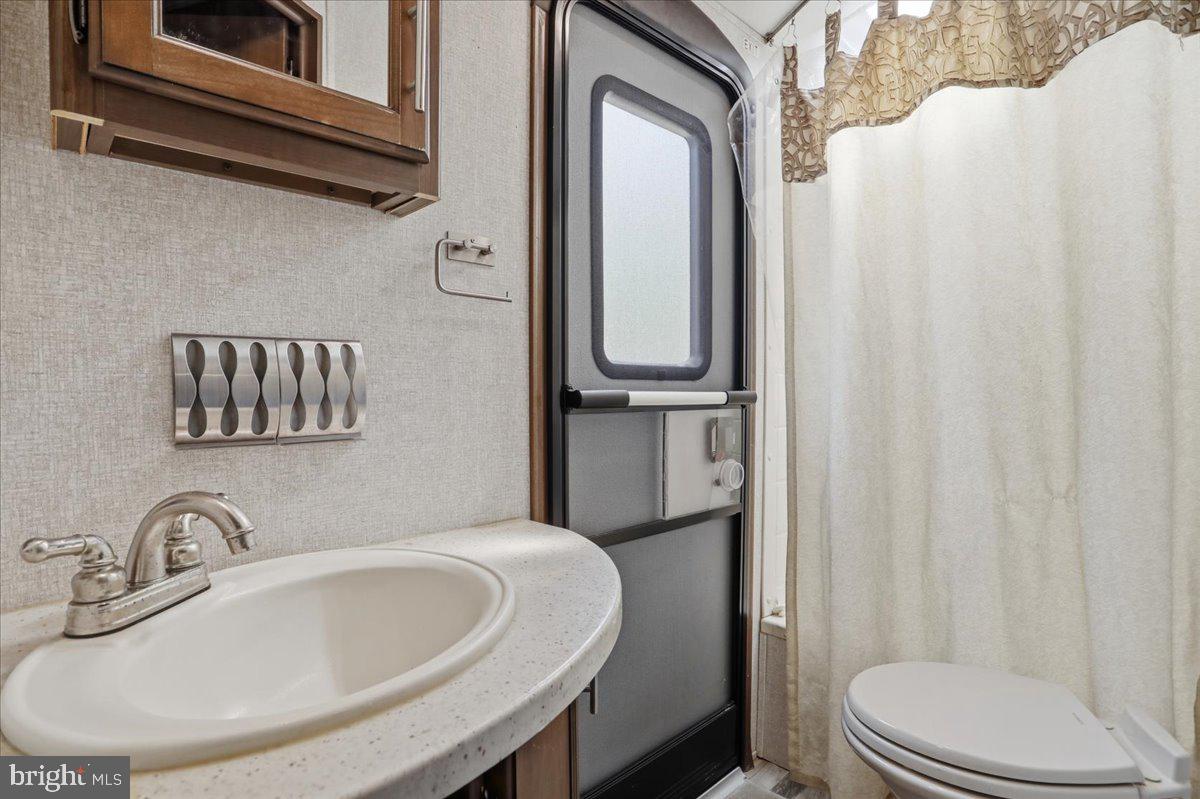399 Buttonwood Trail Romney, WV 26757 - Photo 10 of 29 a bathroom with a sink a toilet and shower