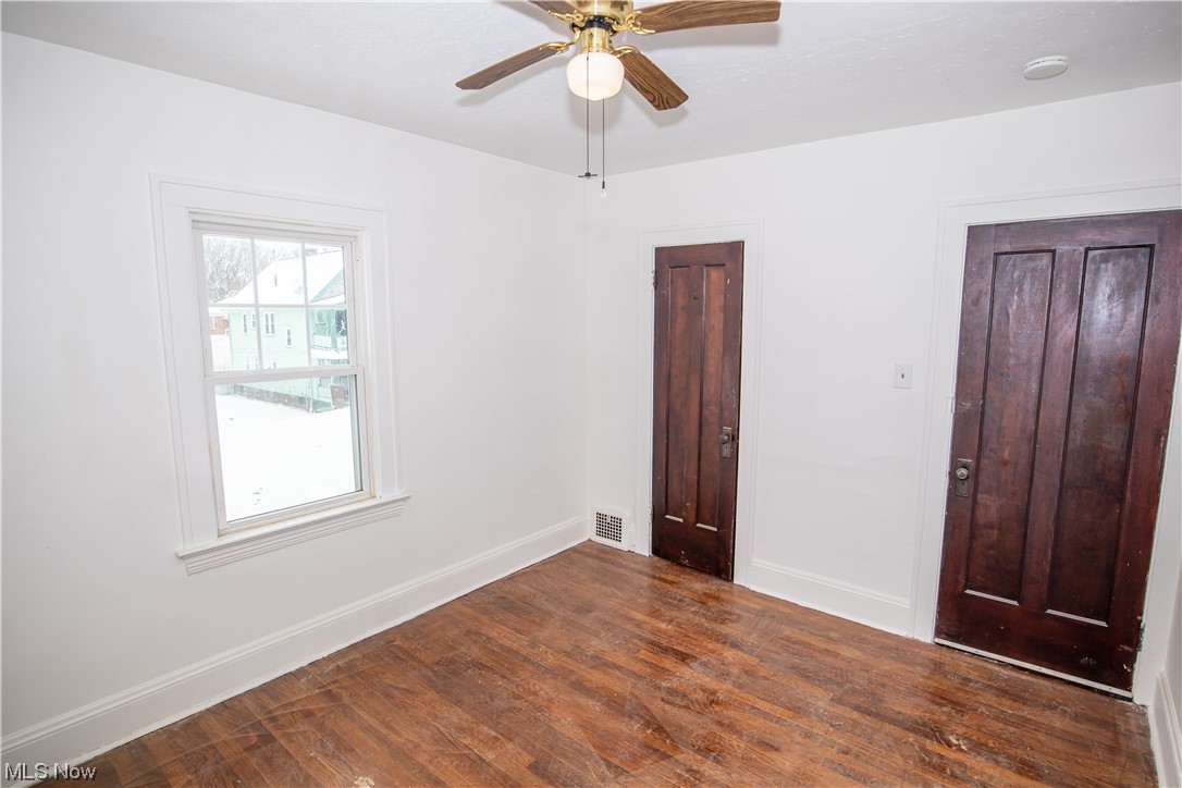 16315 Nela View Road Cleveland, OH 44112 - Photo 18 of 24 Unfurnished bedroom with dark hardwood / wood-style flooring and ceiling fan