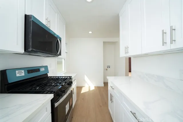 a kitchen with a sink and a stove top oven