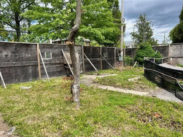 a backyard of a house with trampoline