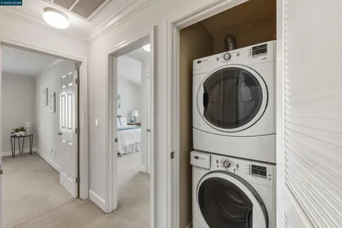 a view of a hallway with washer and dryer