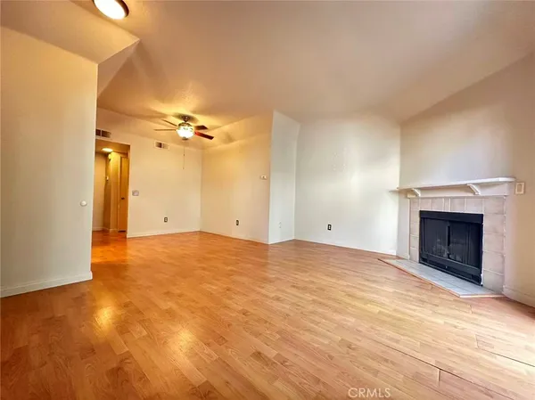 a view of an empty room and a fireplace