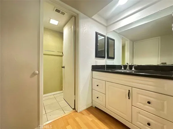 a bathroom with a sink vanity and toilet