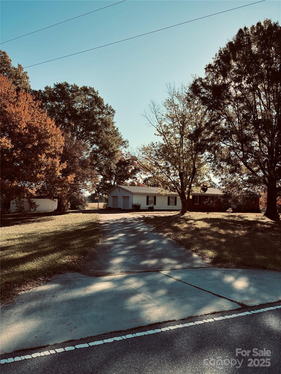 4211 Wolf Pond Road Monroe, NC 28112 - Photo 1 of 36 a view of road with large trees