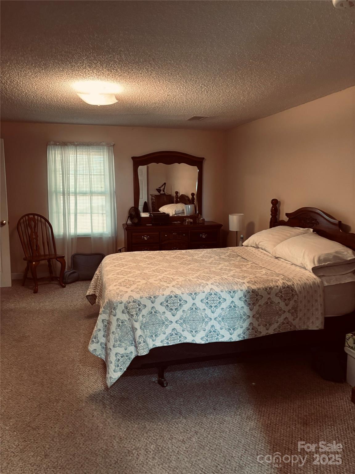 4211 Wolf Pond Road Monroe, NC 28112 - Photo 17 of 36 a bed sitting in a bedroom next to a window