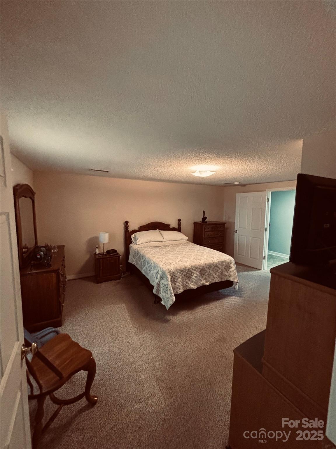 4211 Wolf Pond Road Monroe, NC 28112 - Photo 18 of 36 a bedroom with a bed and furniture
