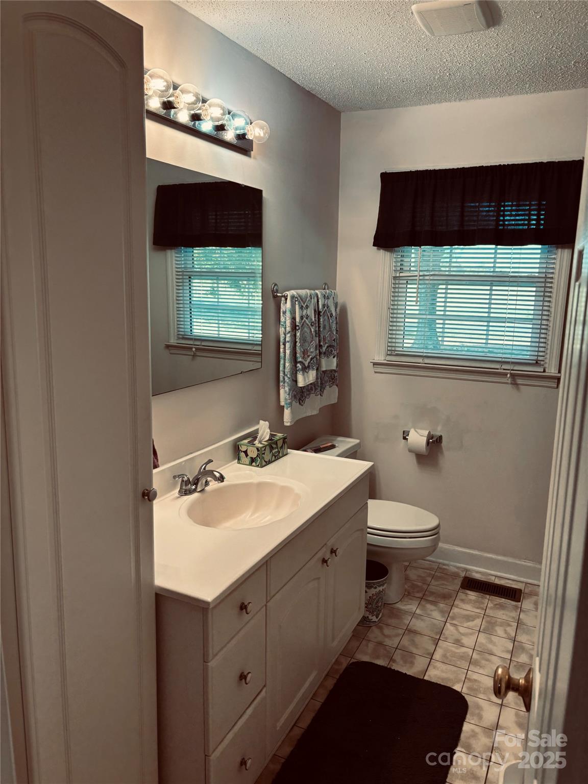 4211 Wolf Pond Road Monroe, NC 28112 - Photo 23 of 36 a bathroom with a sink toilet and mirror