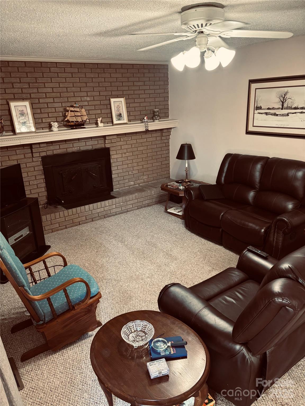 4211 Wolf Pond Road Monroe, NC 28112 - Photo 5 of 36 a living room with furniture and a fireplace