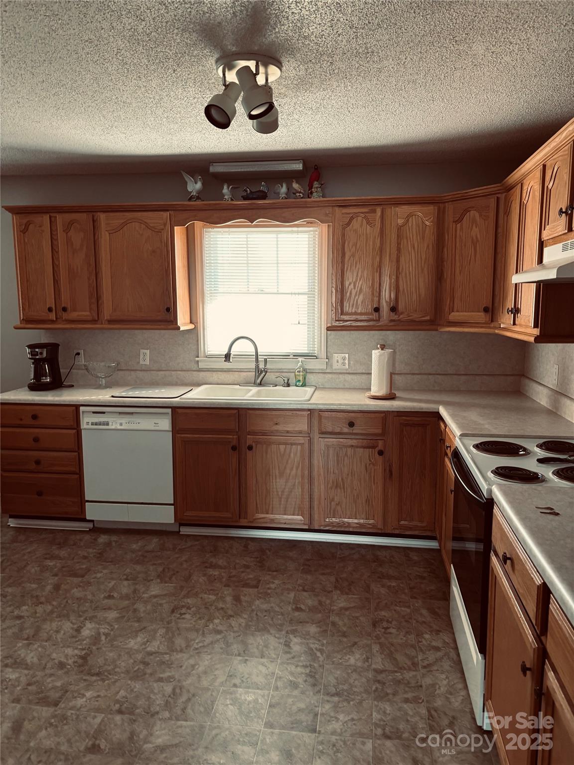 4211 Wolf Pond Road Monroe, NC 28112 - Photo 7 of 36 a kitchen with a sink stove and cabinets