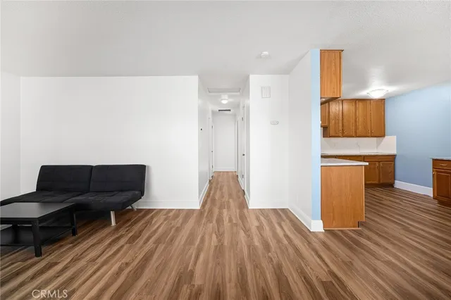 a living room with wooden floor and furniture