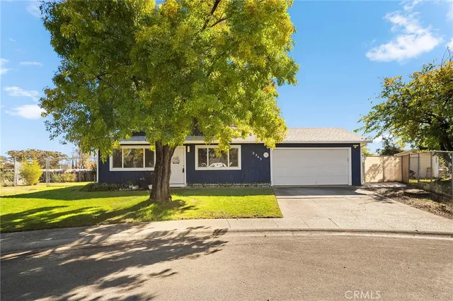 a front view of a house with yard and garage