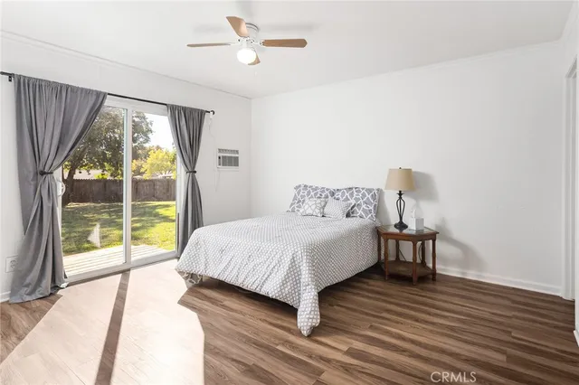 a bedroom with a bed and a large window