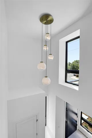 a bathroom with a sink a light fixture and a window