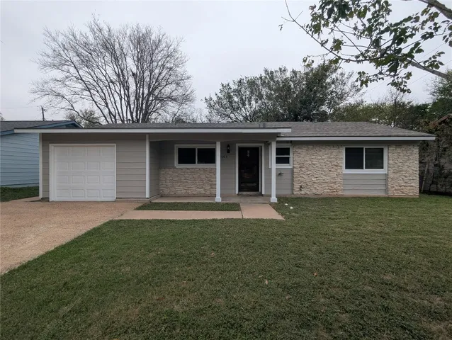 a front view of house with yard and trees