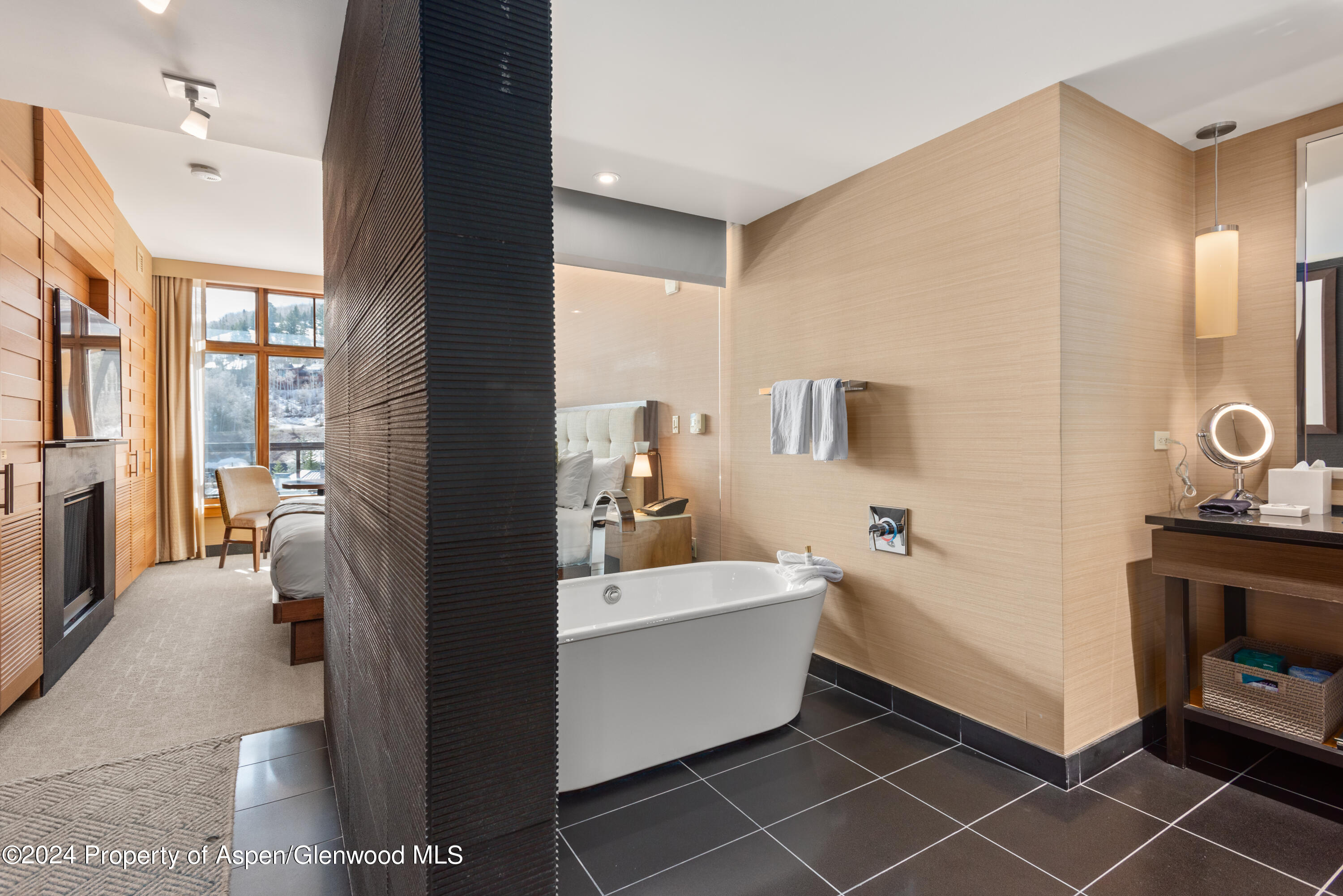 a en suite bathroom with a tub sink and mirror