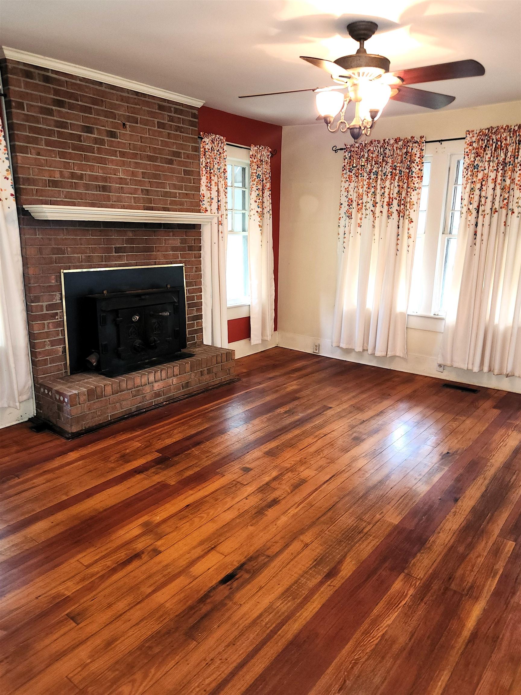 450 Fletcher Road Collierville, TN 38017 - Photo 11 of 25 wooden floor fireplace and windows in an empty room