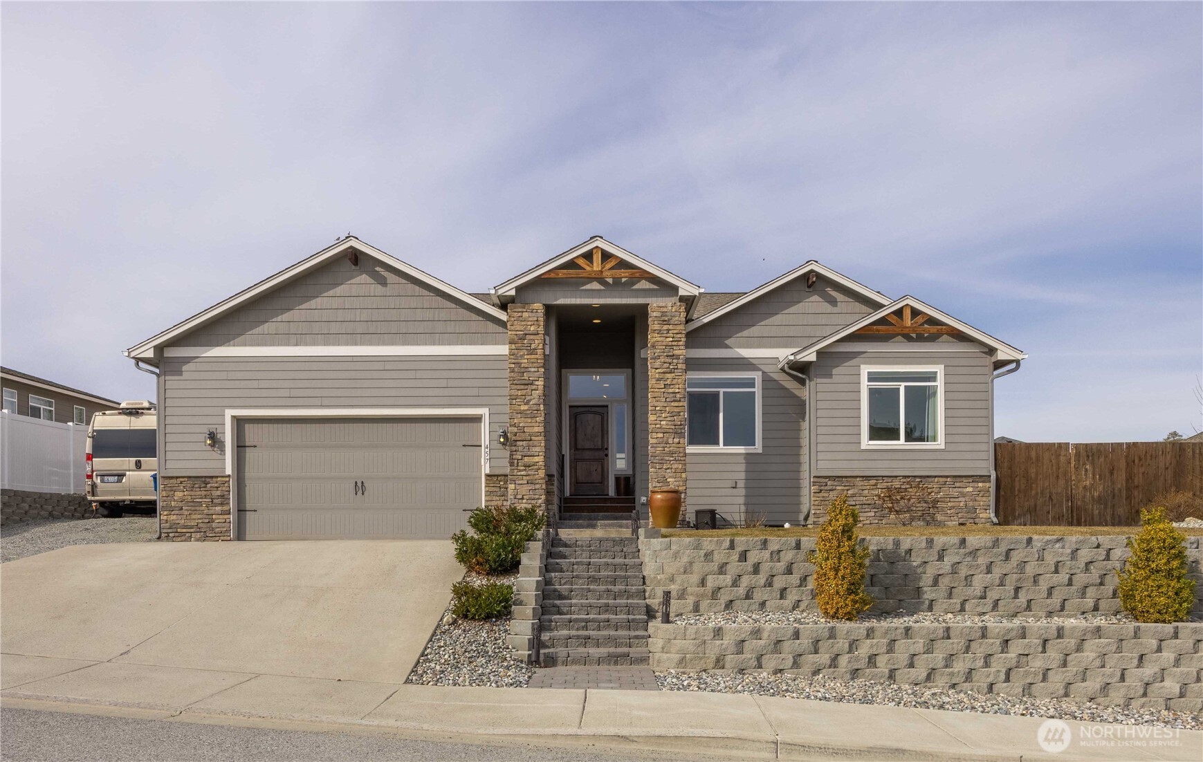 457 Whisper Place Chelan, WA 98816 - Photo 1 of 40 a front view of a house with a yard and garage