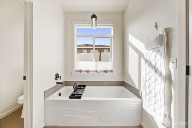 a white bath tub sitting next to a window