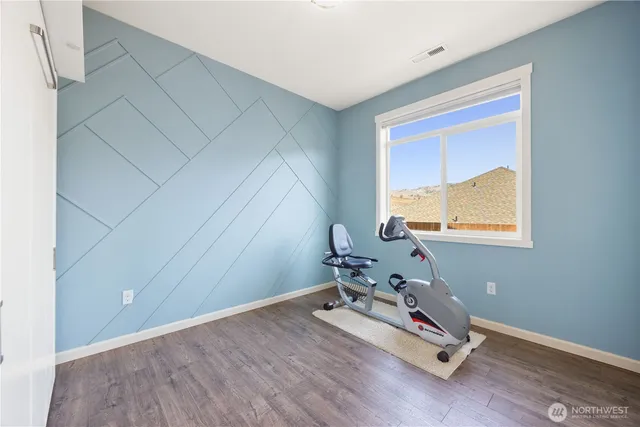 a room with gym equipment and view of living room