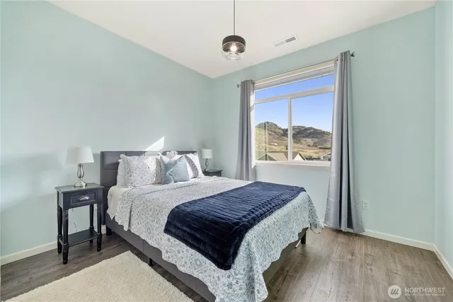 a bedroom with a large bed and a window