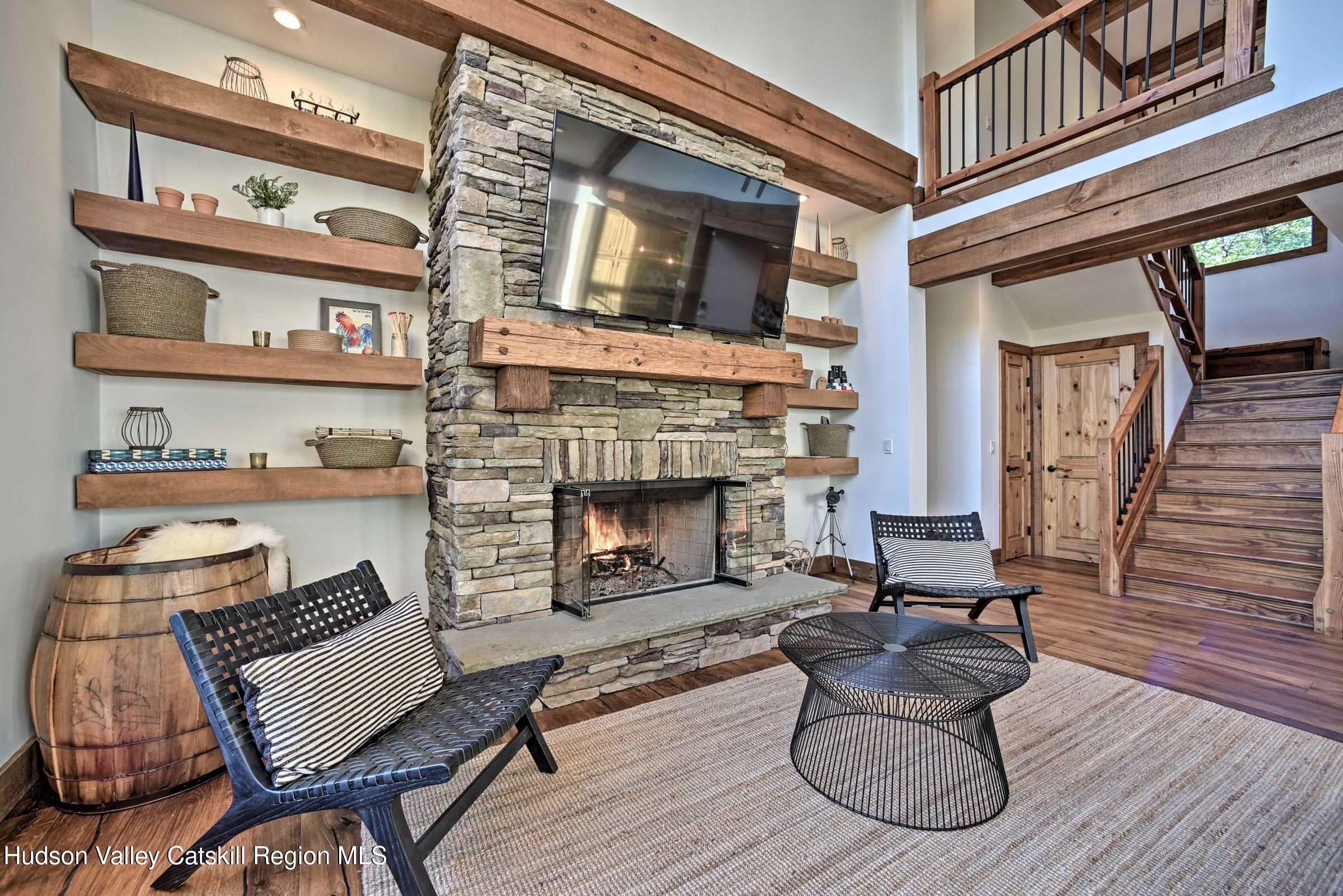 205 Nauvoo Road Windham, NY 12496 - Photo 12 of 31 a living room with furniture and a fireplace