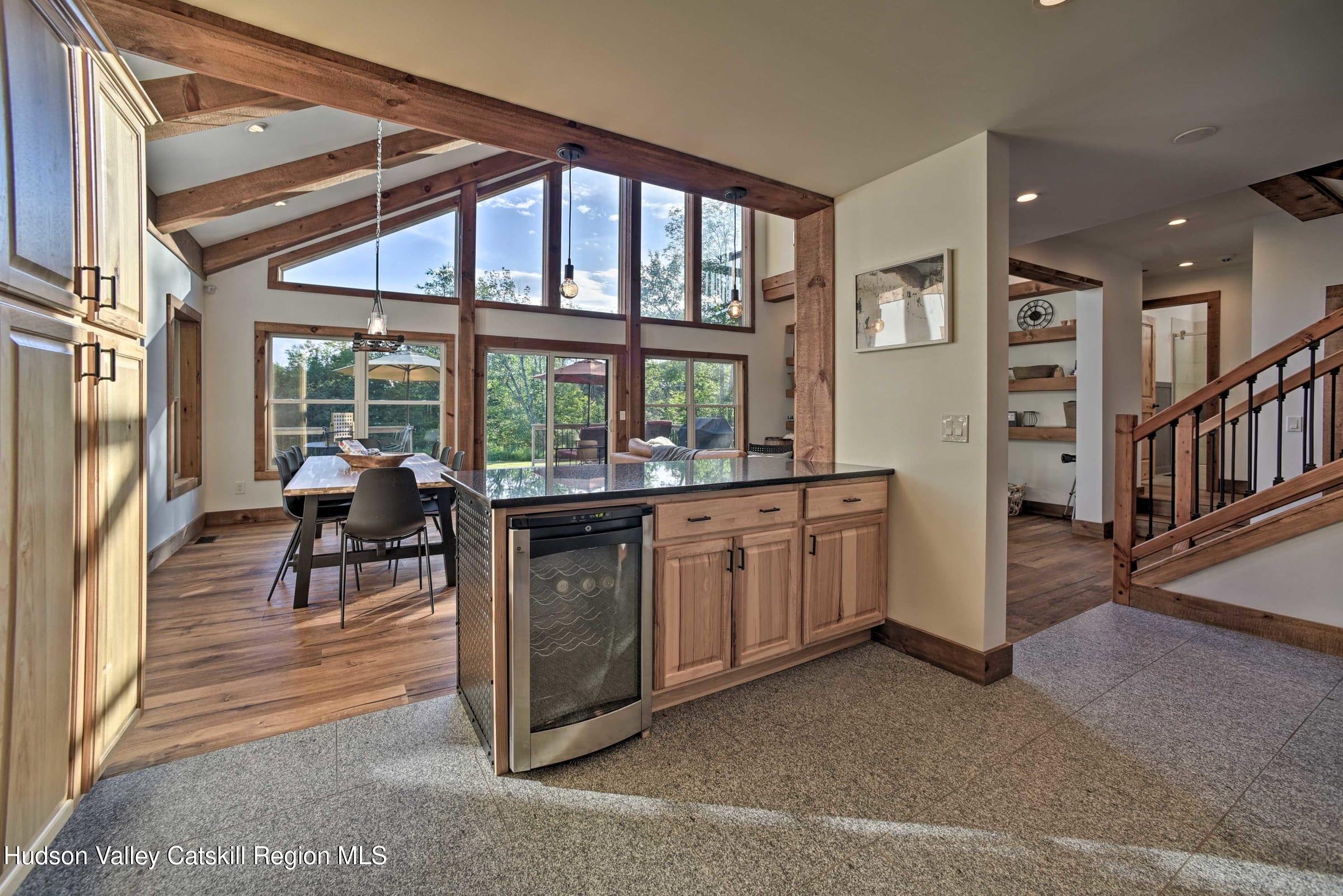 205 Nauvoo Road Windham, NY 12496 - Photo 15 of 31 a dining room with furniture and a floor to ceiling window