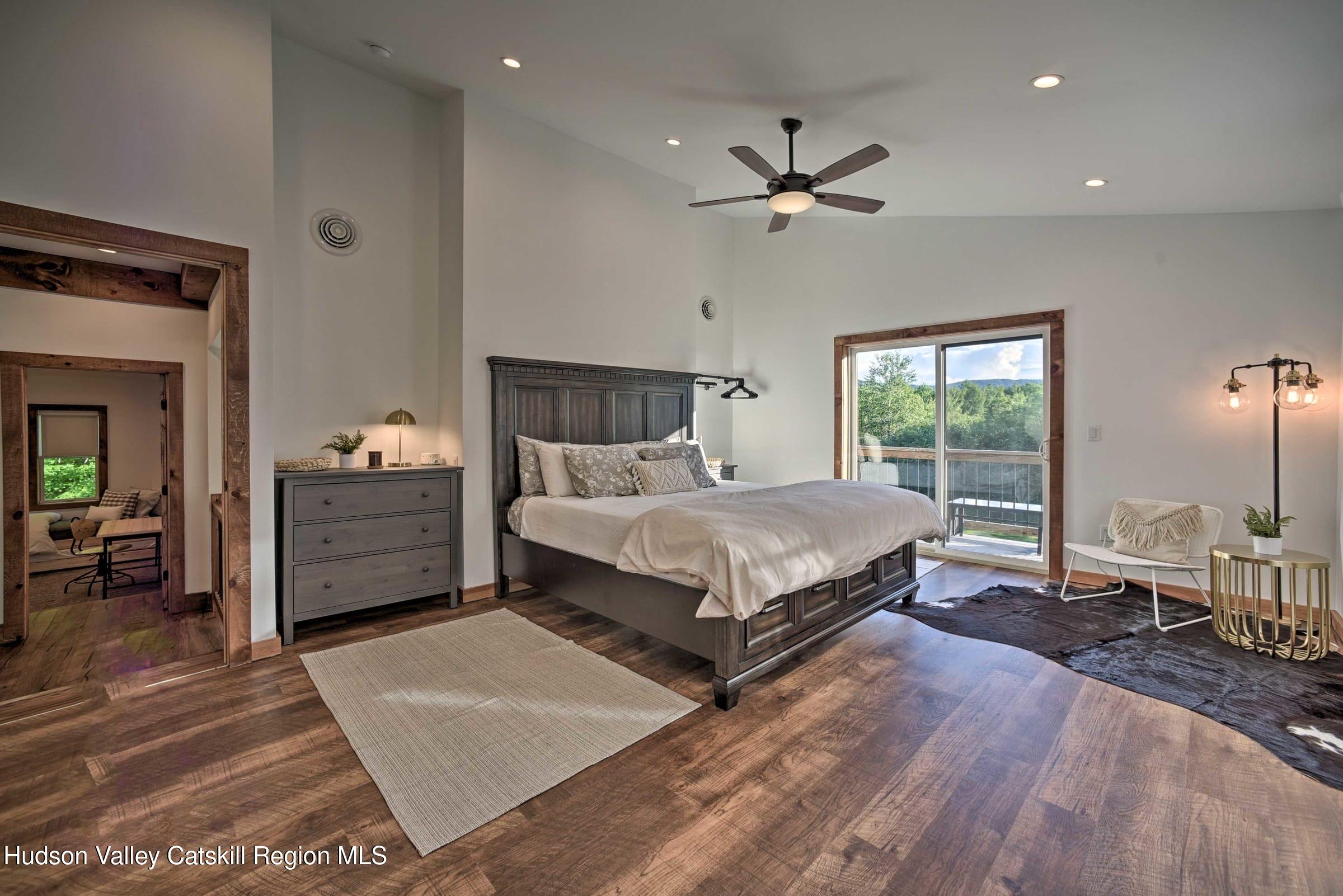 205 Nauvoo Road Windham, NY 12496 - Photo 16 of 31 a bedroom with a large bed and a chandelier