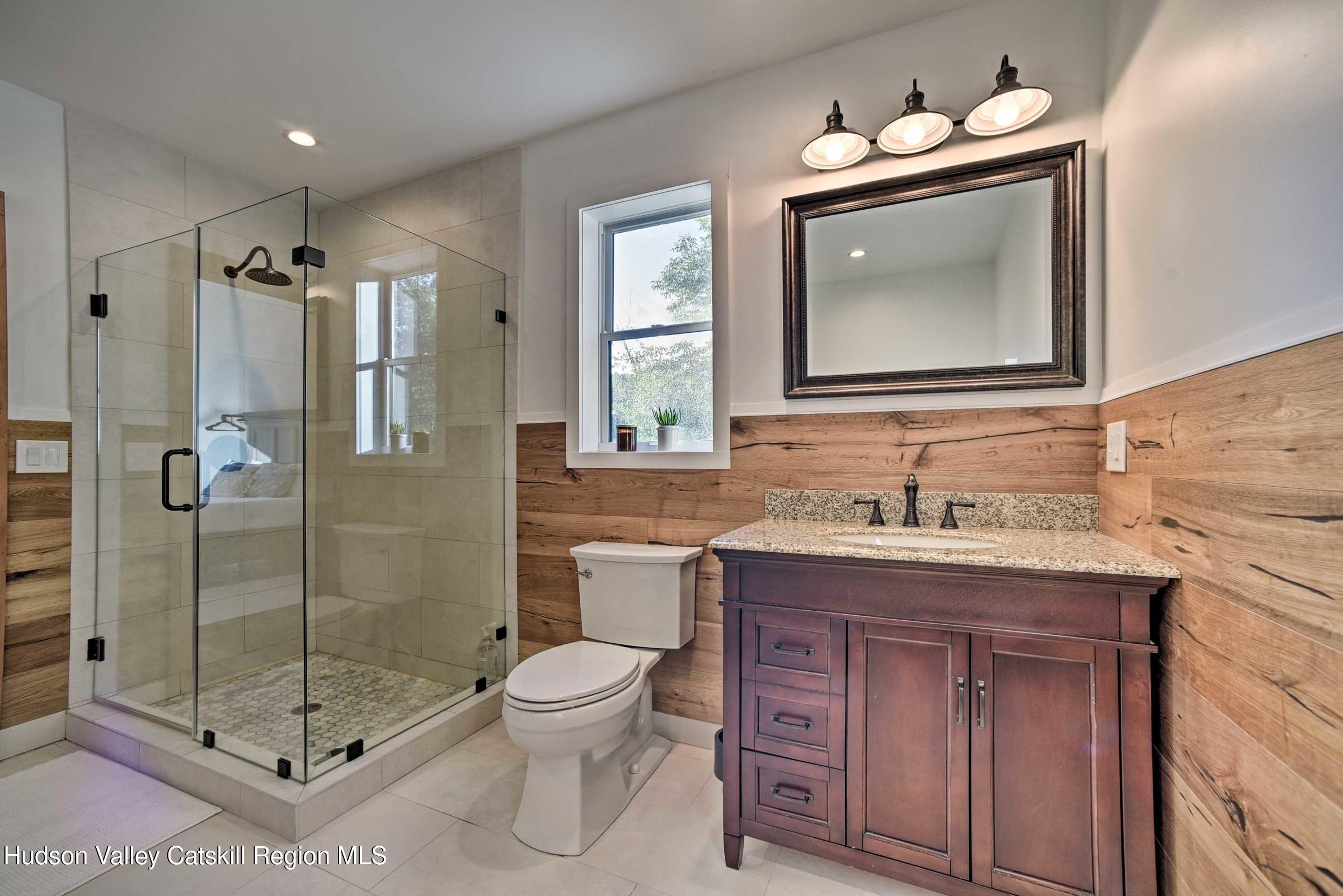 205 Nauvoo Road Windham, NY 12496 - Photo 28 of 31 a bathroom with a toilet sink vanity granite and mirror