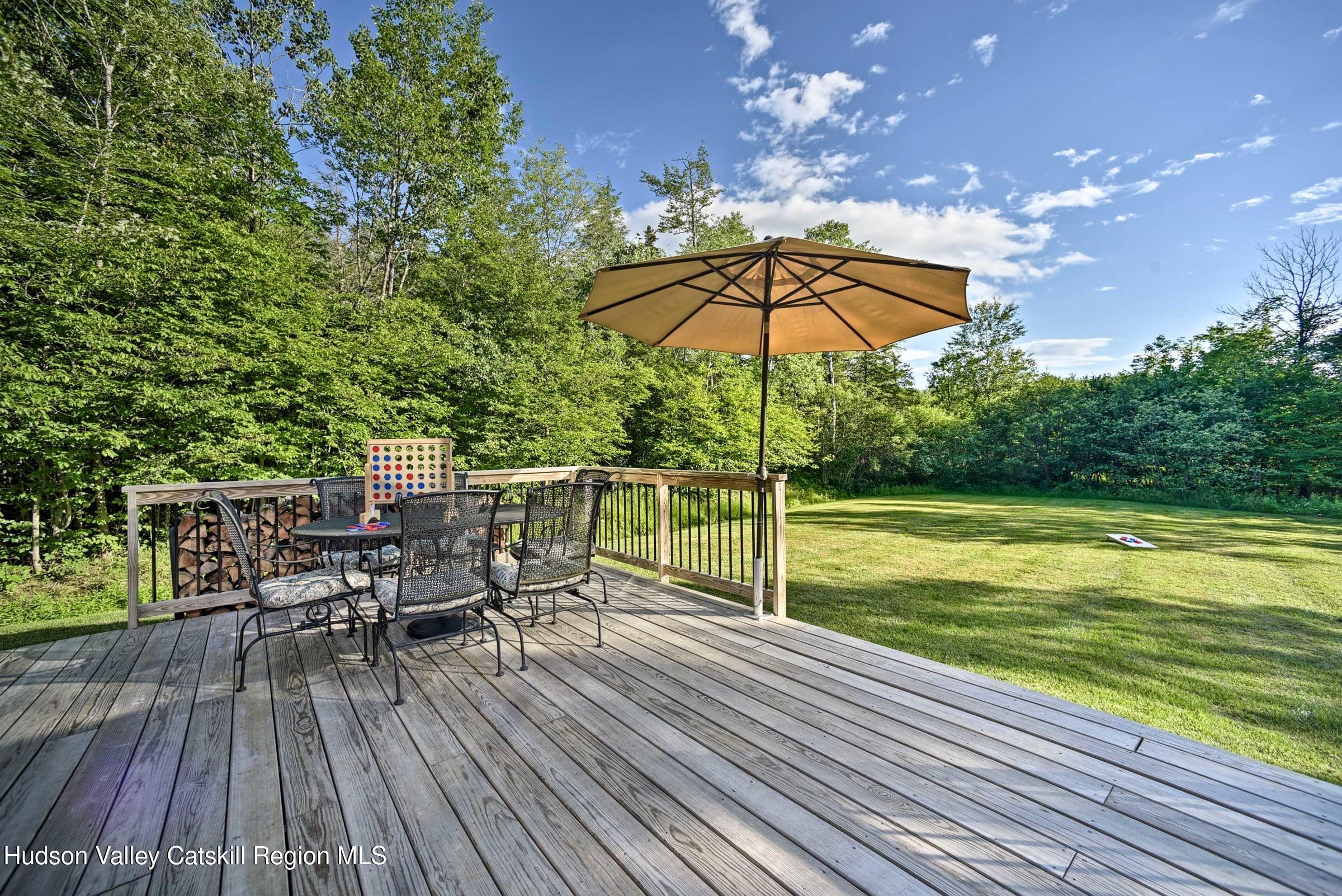 205 Nauvoo Road Windham, NY 12496 - Photo 7 of 31 a view of a chair and table on the wooden deck
