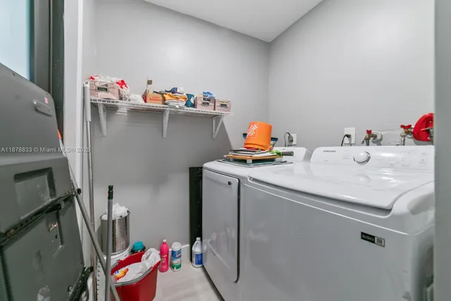 a utility room with sink dryer and washer
