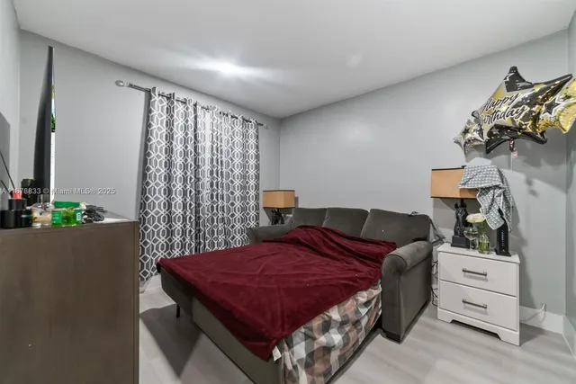 a bedroom with a bed and a dresser