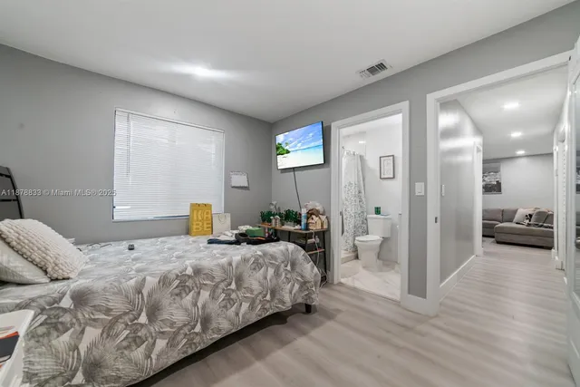 a bedroom with a large bed and a walk in closet