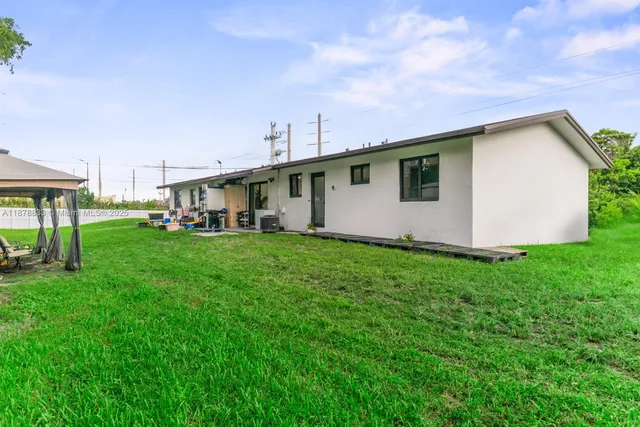 a white house sitting in middle of the grass