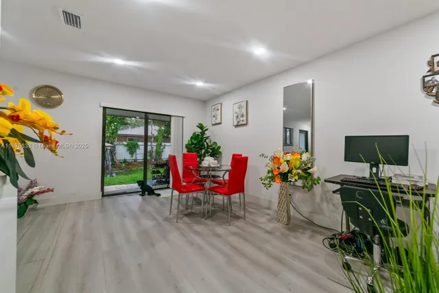 a living room with furniture gym equipment and a flat screen tv