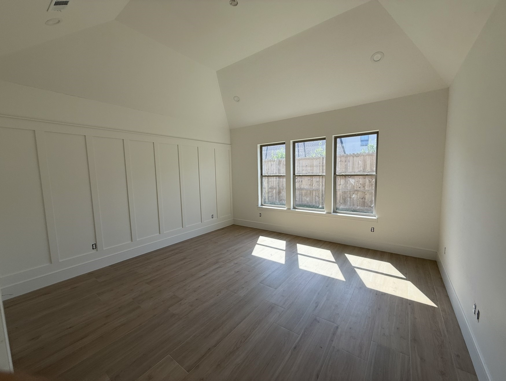 3541 Lily Lane Beaumont, TX 77713 - Photo 8 of 12 an empty room with wooden floor and windows