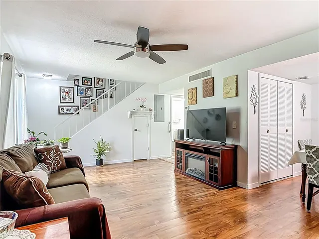 a living room with furniture and wooden floor