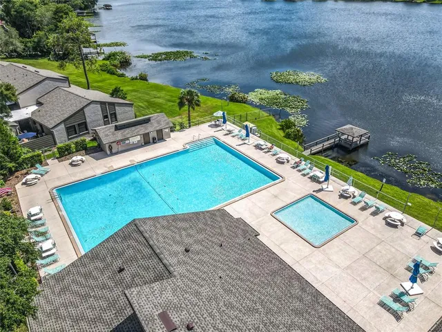a swimming pool with outdoor seating and yard