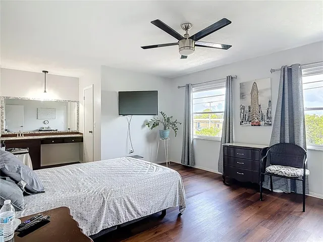 a bedroom with a bed and ceiling fan